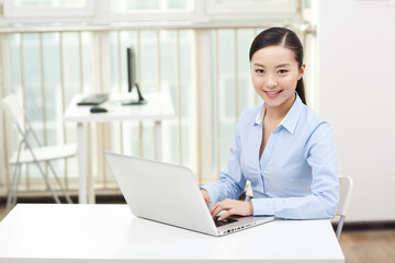 A Young woman using laptop in office