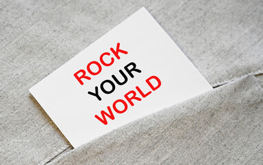 ROCK YOUR WORLD text on white sticker in a shirt pocket.