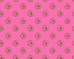 Pink doughnuts with hearts seamless pattern on pink background