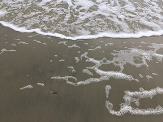 waves over beach sand