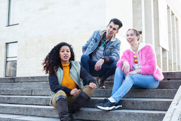 Fototapeta premium cute group of teenages at the building of university with books huggings, diversity nations real students lifestyle