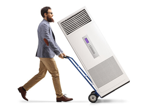Bearded Man Pushing A Hand-truck With A Portable Self Standing Ac Unit