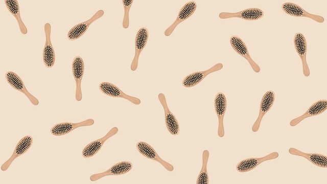 seamless looping animation with wooden hairbrushes that wiggle on a beige pastel background close-up
