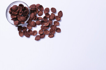 Chocolate flakes on ultimate gray background with large blank space for your ad.