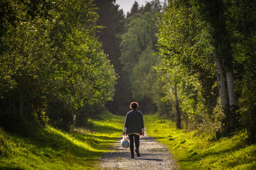 A woman enjoys a walk in the Irish forest
