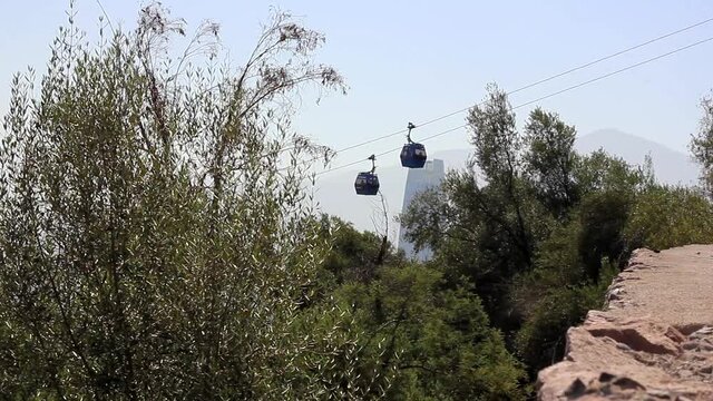Cable cars crossing at San Cristobal mountain in Santiago, Chile. Aerial tramway transportation on sunny day