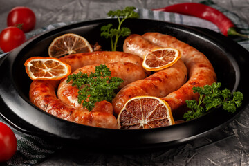 Homemade chicken sausage in spices and lemon in a pan