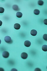  Spirulina algae tablets.Dietary supplements. Spirulina pills set on a turquoise background.Super food. Healthy organic seaweed. Food product.Dry algae tablets