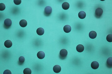  Spirulina algae tablets.Dietary supplements. Spirulina pills set on a turquoise background.Super food. Healthy organic seaweed.Healthy lifestyle. Food product.Dry algae tablets