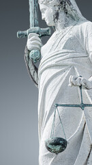 Ancient roof statue of goddess Justice with sword and scale isolated as a decoration at the top of...