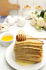 Thin pancakes with honey. healthy food. Maslenitsa is a traditional Russian and Ukrainian holiday.