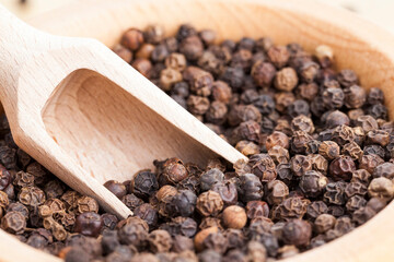 black peas pepper on an old wooden table
