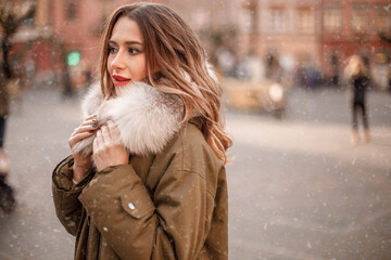 Elegant girl walk in a winter city. Beautiful lady with blond hair. Portrait of beautiful blond...