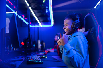 Professional Streamer African young woman cyber gamer in neon color background