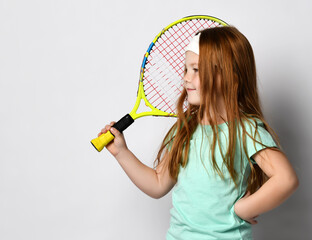 Redhead girl playing tennis head shot studio portrait isolated on white.