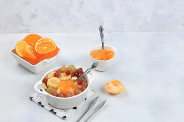 Fruit salad with grapes, tangerines, banana and jam for weight loss. Useful breakfast, Healthy and natural food concept, detox diet, lifestyle, weight loss, selective focus,