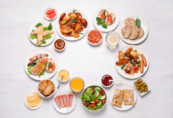 Buffet service. Frame of different dishes on white wooden table, space for text