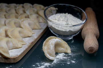 Pierogi pelmeni placing the filling into a dough pocket 