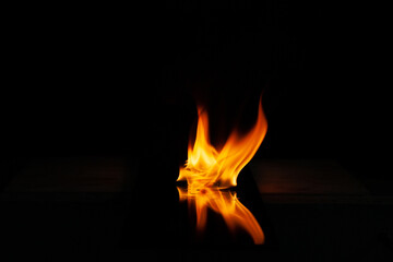 fire flame with reflection in the glass on a black background