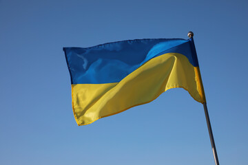 National flag of Ukraine against blue sky