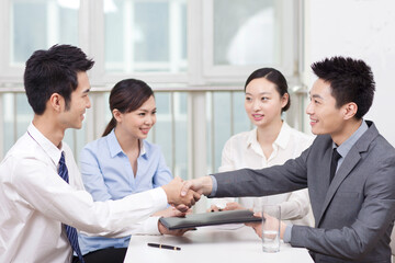 Young Business men shaking hands at office 