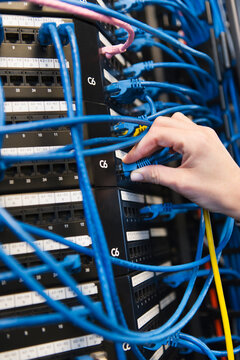 Close-up of female IT support technician repairing server
