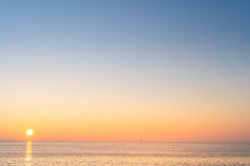 Panorama of Re island seascape with a little lighthouse in the horizon at sunrise on a very calm sea. beautiful minimalist seascape.