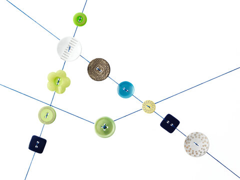Studio shot of diagram made of thread and buttons