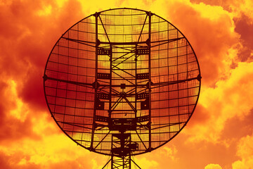the radar on the background of an orange sky - 405298752