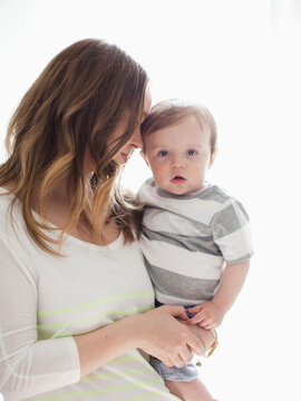Portrait of young woman embracing baby boy (6-11 months)