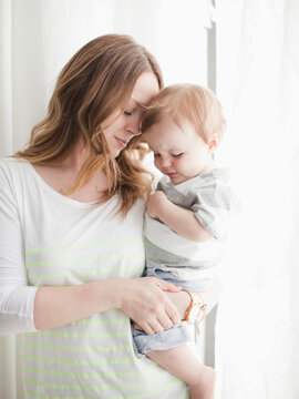 Portrait of young woman embracing baby boy (6-11 months)