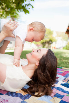 Young mother kissing toddler boy ( 2-3)