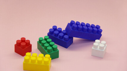 cubes and blocks of a multi-colored constructor on a light background
