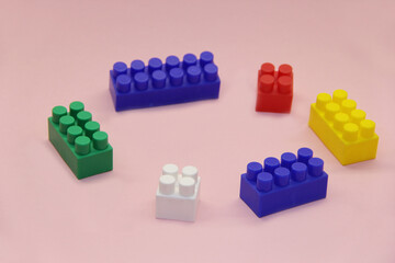 cubes and blocks of a multi-colored constructor on a light background