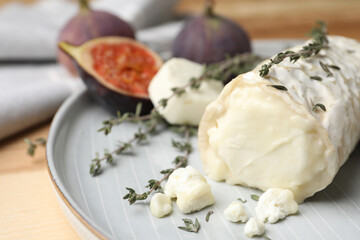 Delicious goat cheese with thyme on plate, closeup