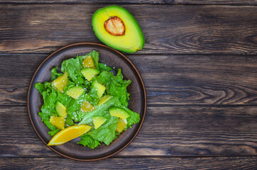 fresh summer homemade salad of vegetables and fruits, orange, lettuce, avocado and sesame seeds, healthy food, organic, vegetarian eco health and immunity products