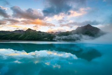 amazing clouds during sunset in the mountains and a lake (Montafon, Vorarlberg, Austria)