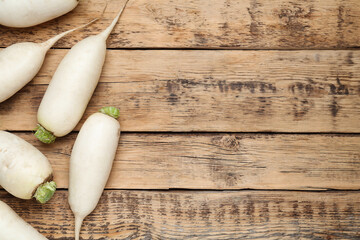 White turnips on wooden table, flat lay. Space for text
