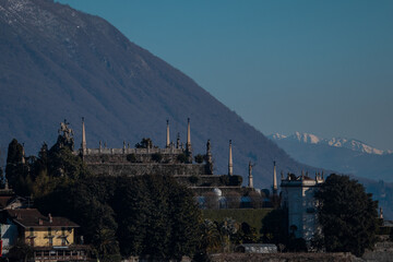 Isola Bella on Lake Maggiore, italy with view of the island and Palazzo Borromeo on a cold winter day. Snowy mountains in the background.