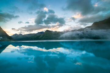 amazing clouds during sunset in the mountains and a lake (Montafon, Vorarlberg, Austria)