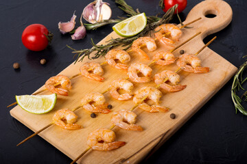 shrimp on skewers on a board
