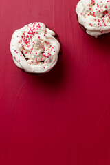 cupcakes with whipped cream and red sprinkles 