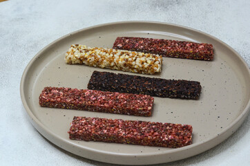 set of oatmeal, buckwheat and rice cereal bars on wooden table, protein sports food for weight control