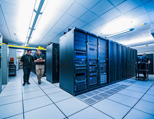 Co-workers walk through data center server room