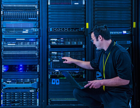 Employee pointing at server rack in data center
