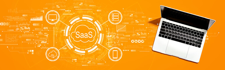 SaaS - software as a service concept with a laptop computer on a desk