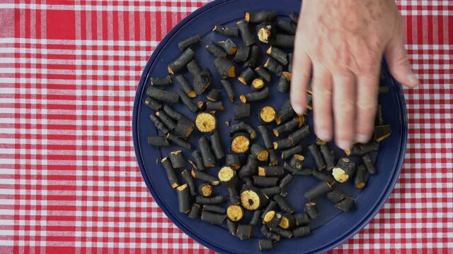 Drying small pieces of Comfrey root for medical use (Symphytum officinale) - (4K)