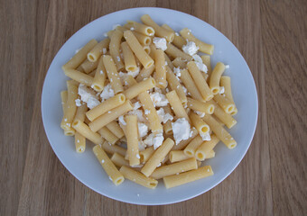 Pasta with cheese on wooden background, delicious food