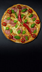 Pizza time. Pizza clock over black background. Vertical frame for a smartphone. Copy space. Creative design.
