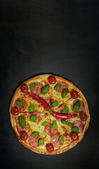 Pizza time. Pizza clock over black background. Vertical frame for a smartphone. Copy space. Creative design.